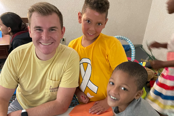 Children and student smiling facing the camera