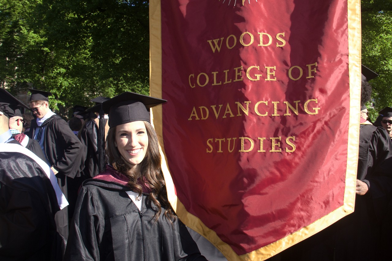 graduate with the Woods College banner