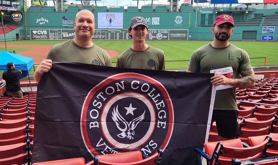 Veterans in a stadium holding the BC Veterans flag