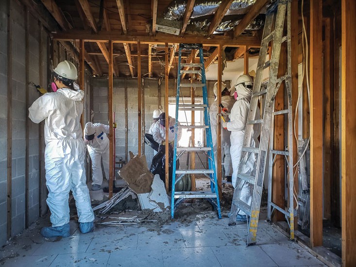 Workers repairing the interior of a house