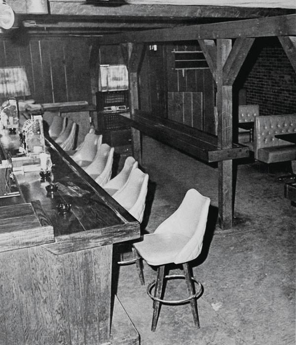 Black and white photograph of the interior of a bar
