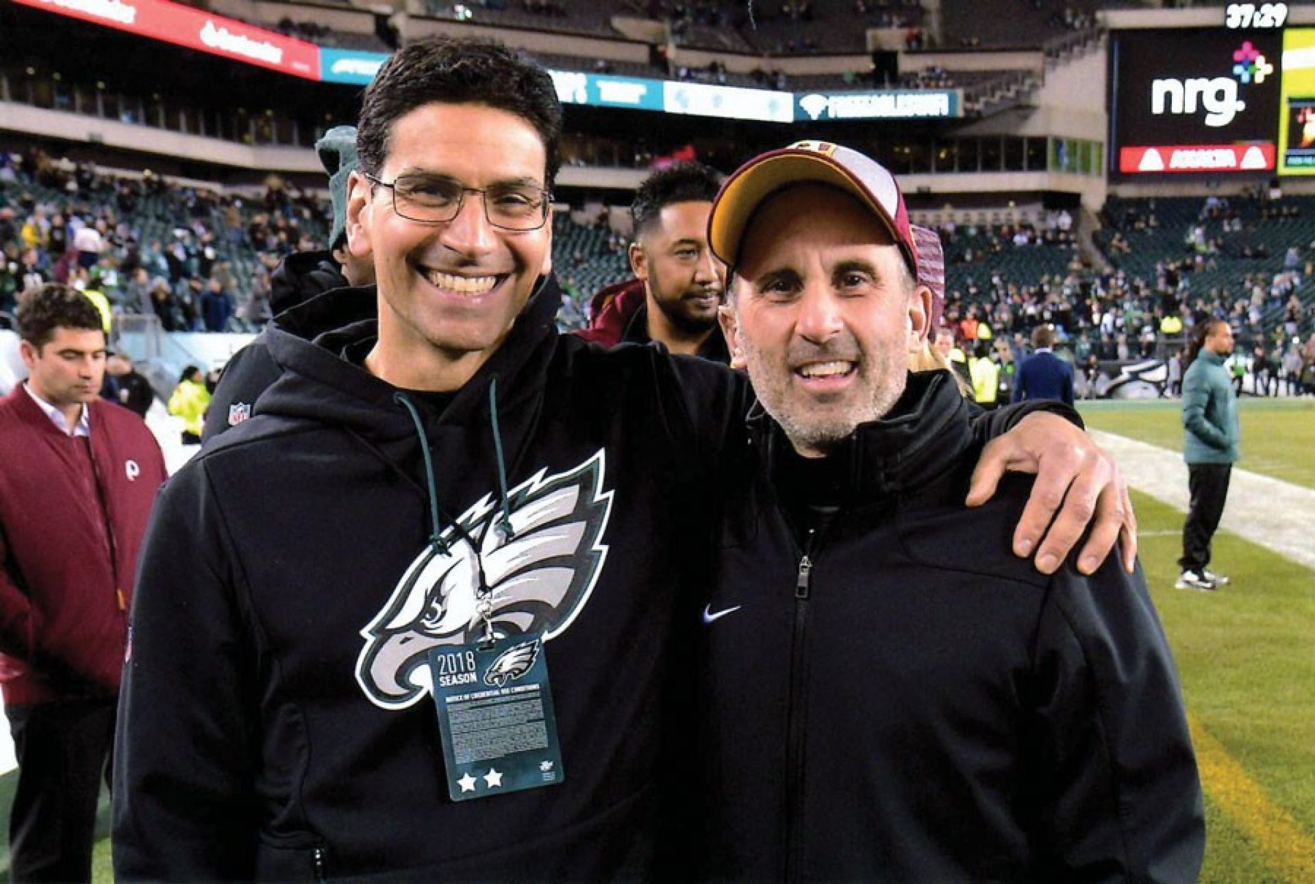 Matt Pepe and Chris Annunziata on the sidelines of a football field