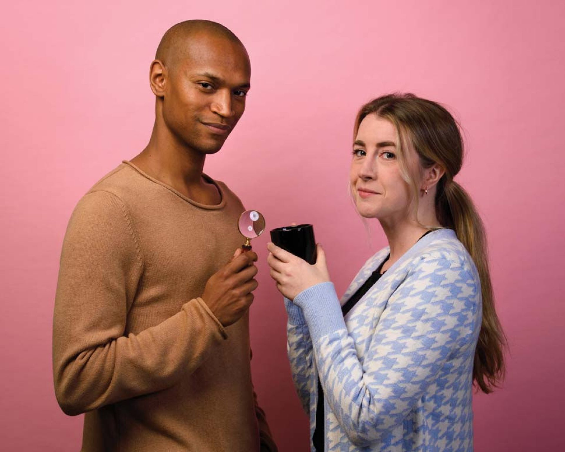 Photo of Griff Stark-Ennis ’14 and Ceara O’Sullivan ’14 holding a magnifying glass and a mug