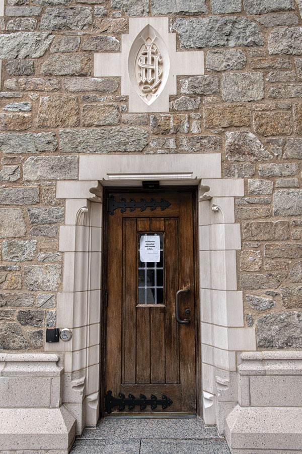 A small paper sign taped to a door