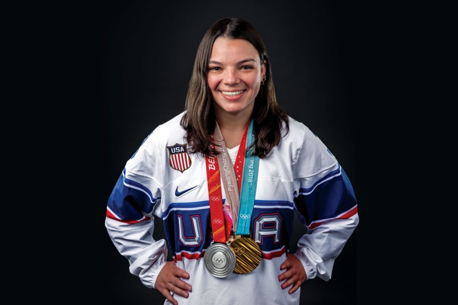 Cayla Barnes smiling with two Olympic medals