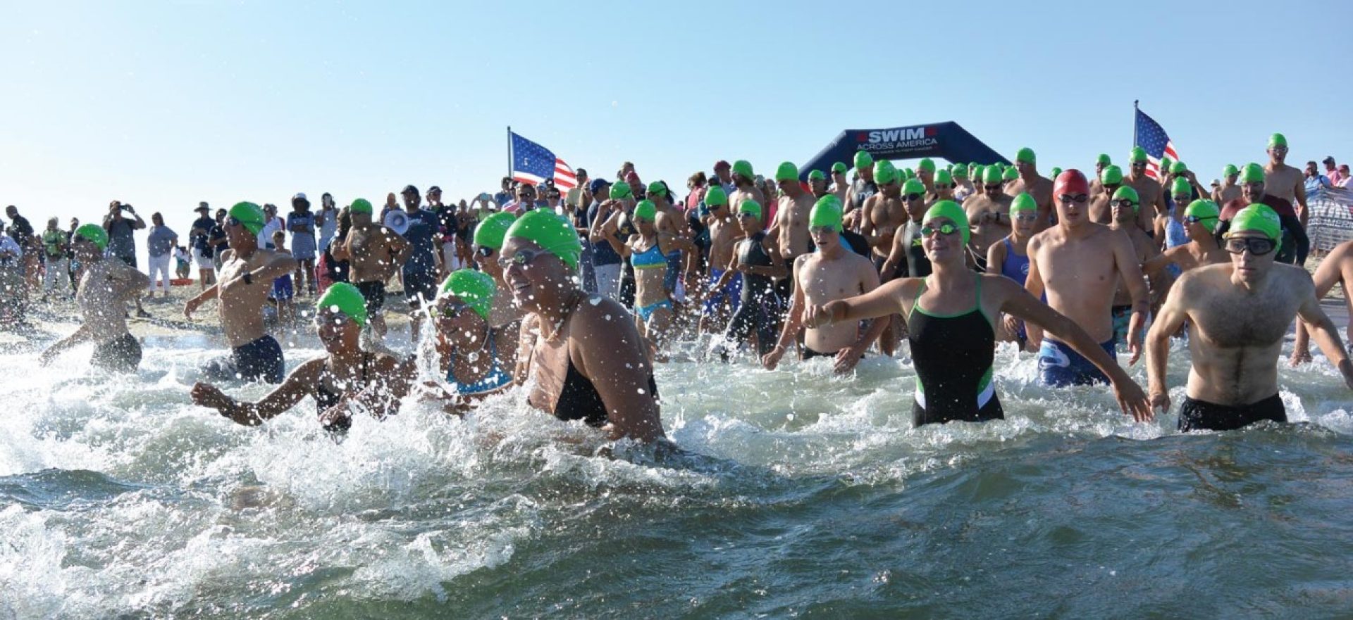 Swimmers running into the water 