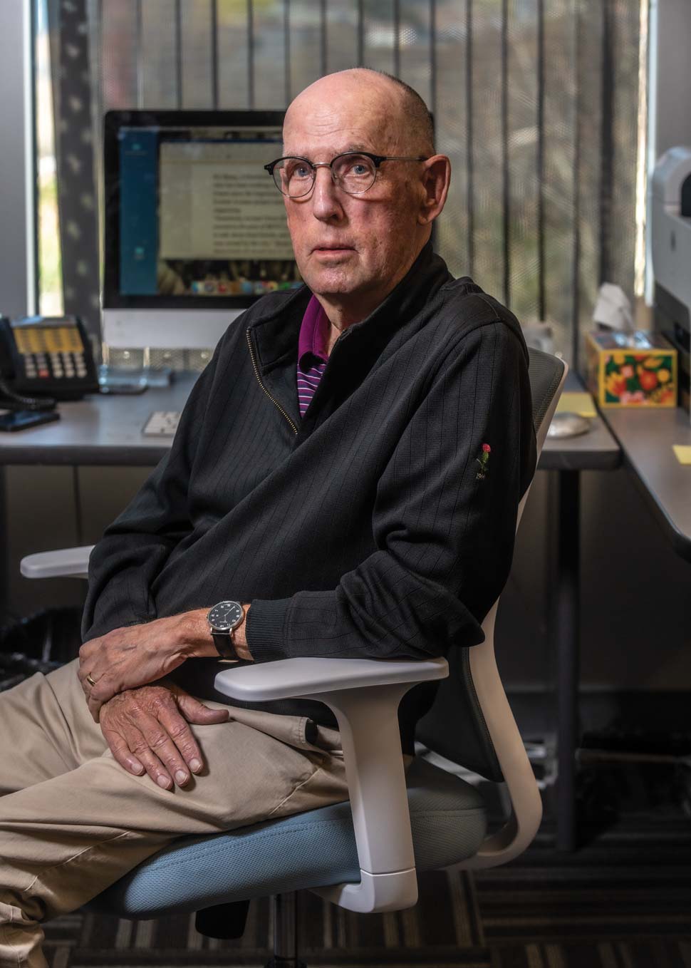 Photo of Tom Mulvoy at his desk.