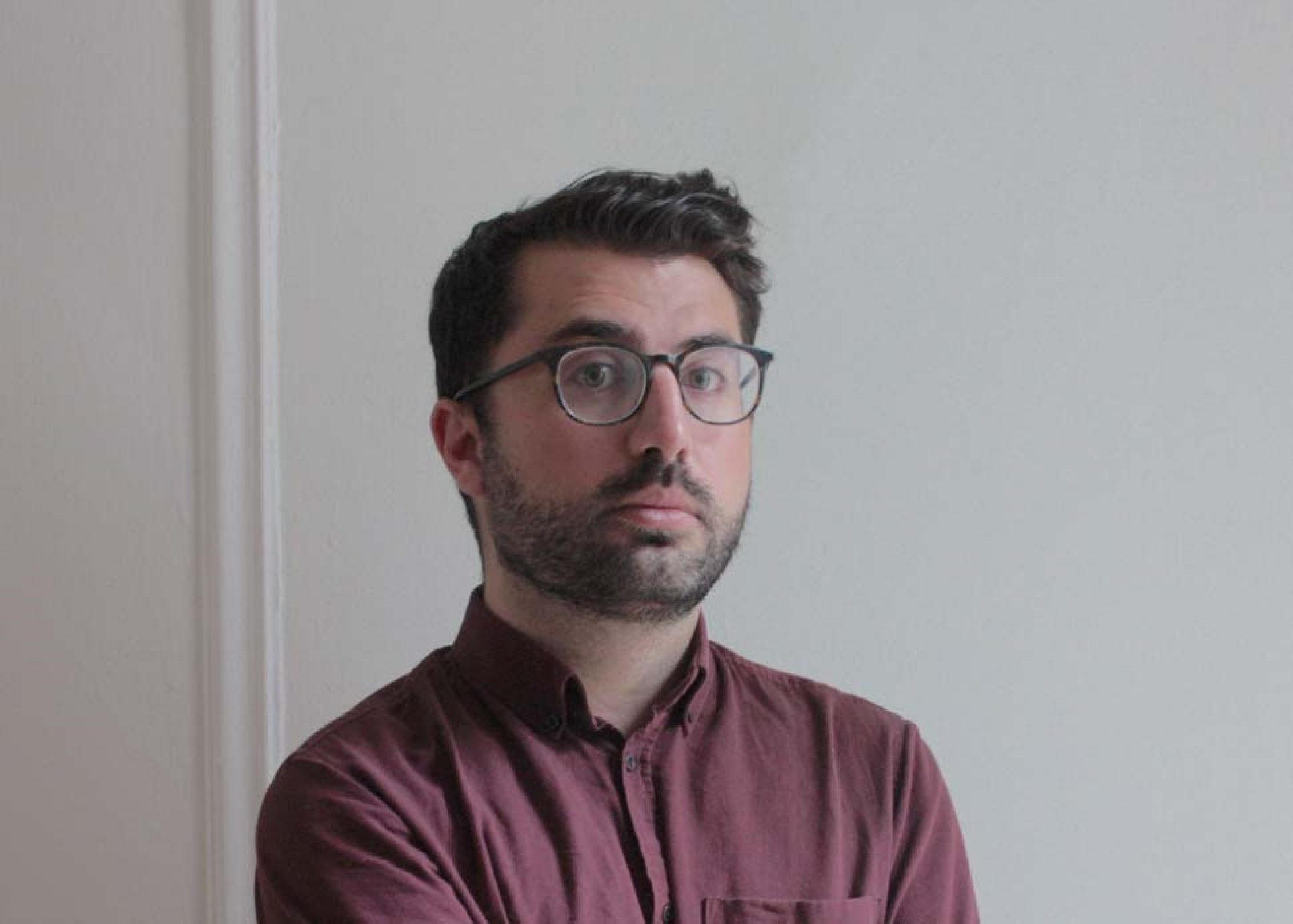 Lawson photographed with a gray wall in the background
