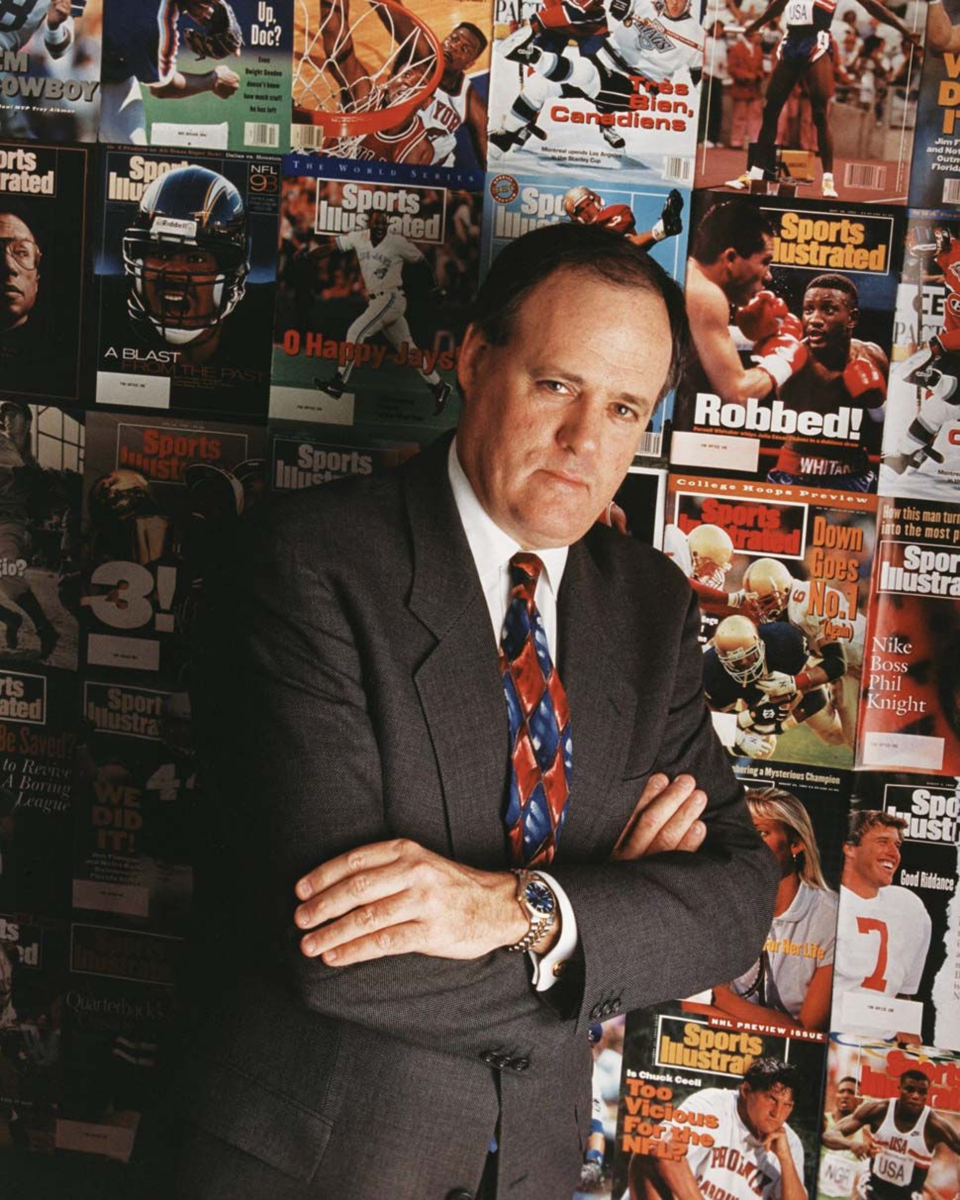 Mulvoy as photographed in front of a wall of Sports Illustrated magazine covers