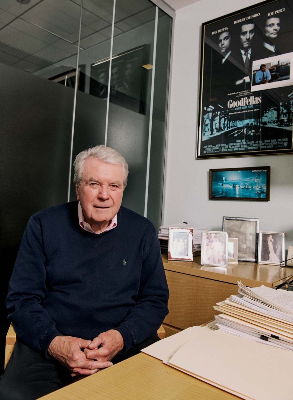 Photo of Edward McDonald in his office with a Goodfellas poster in the background