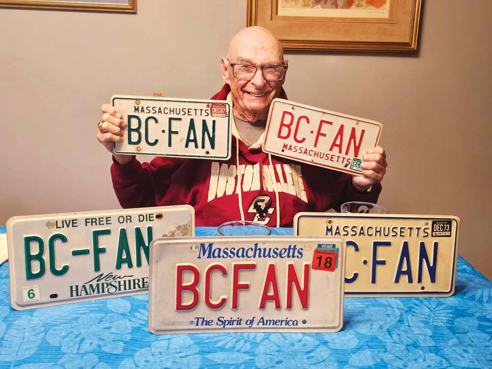 Photo of Ron Saloman with personalized license plates inscribed with BC FAN.
