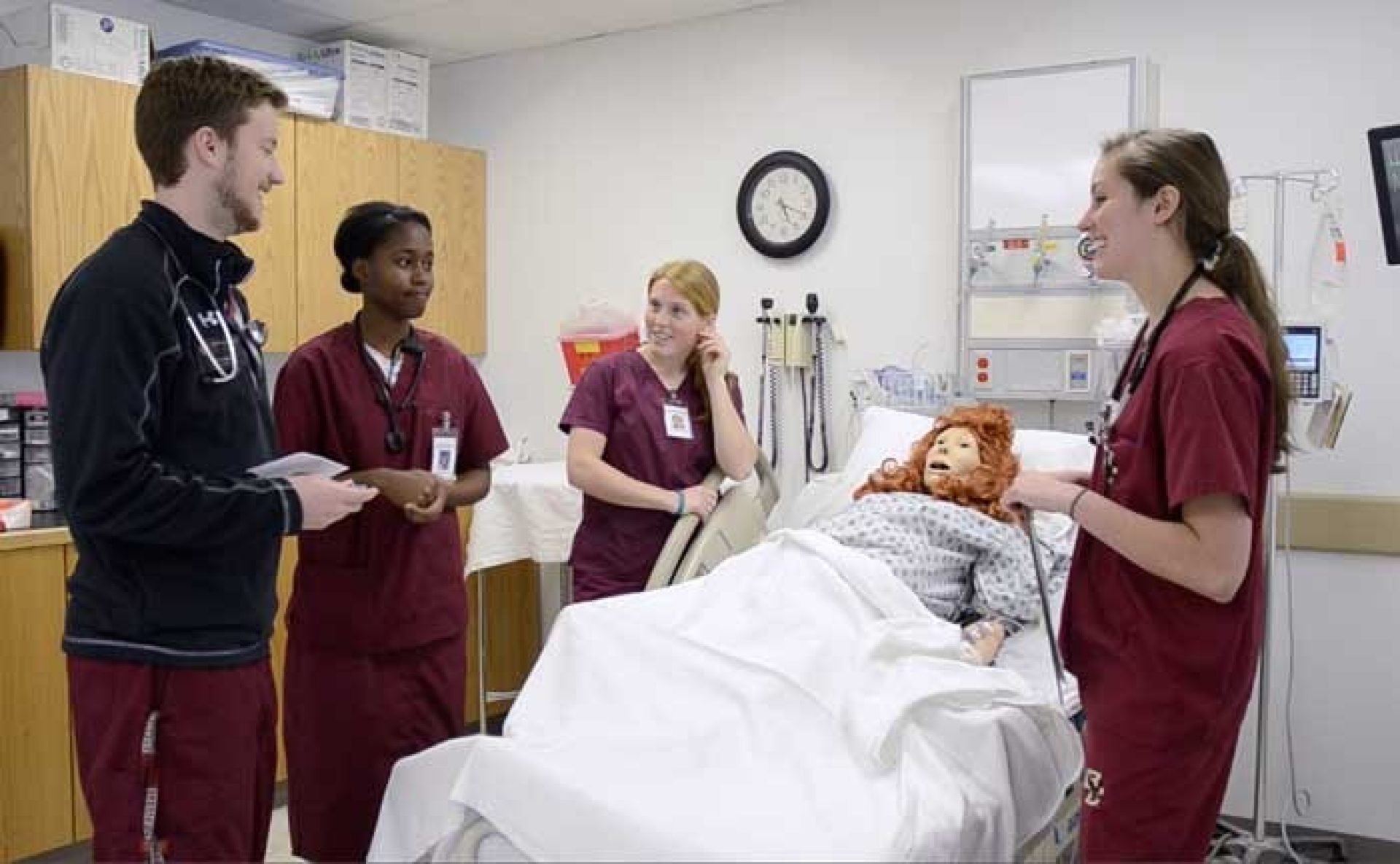 students in scrubs in a hospital setting