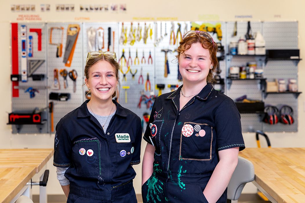 Two students standing in a makerspace