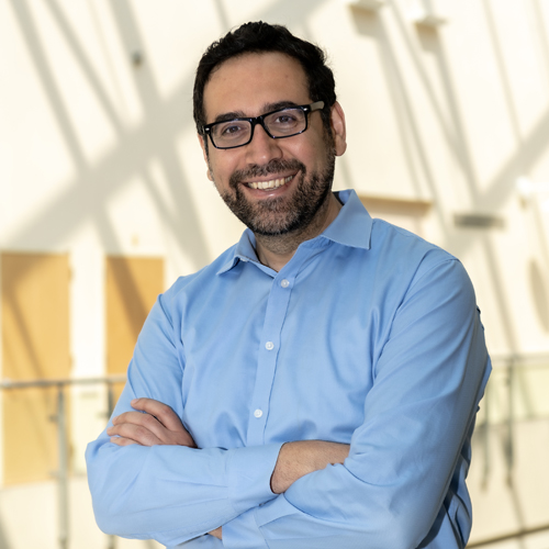 Portrait of Assist. Prof. Emrah Altindis in the Higgins Atrium and a group photo of his research team, both undergrads and graduate students in Emrah's lab.