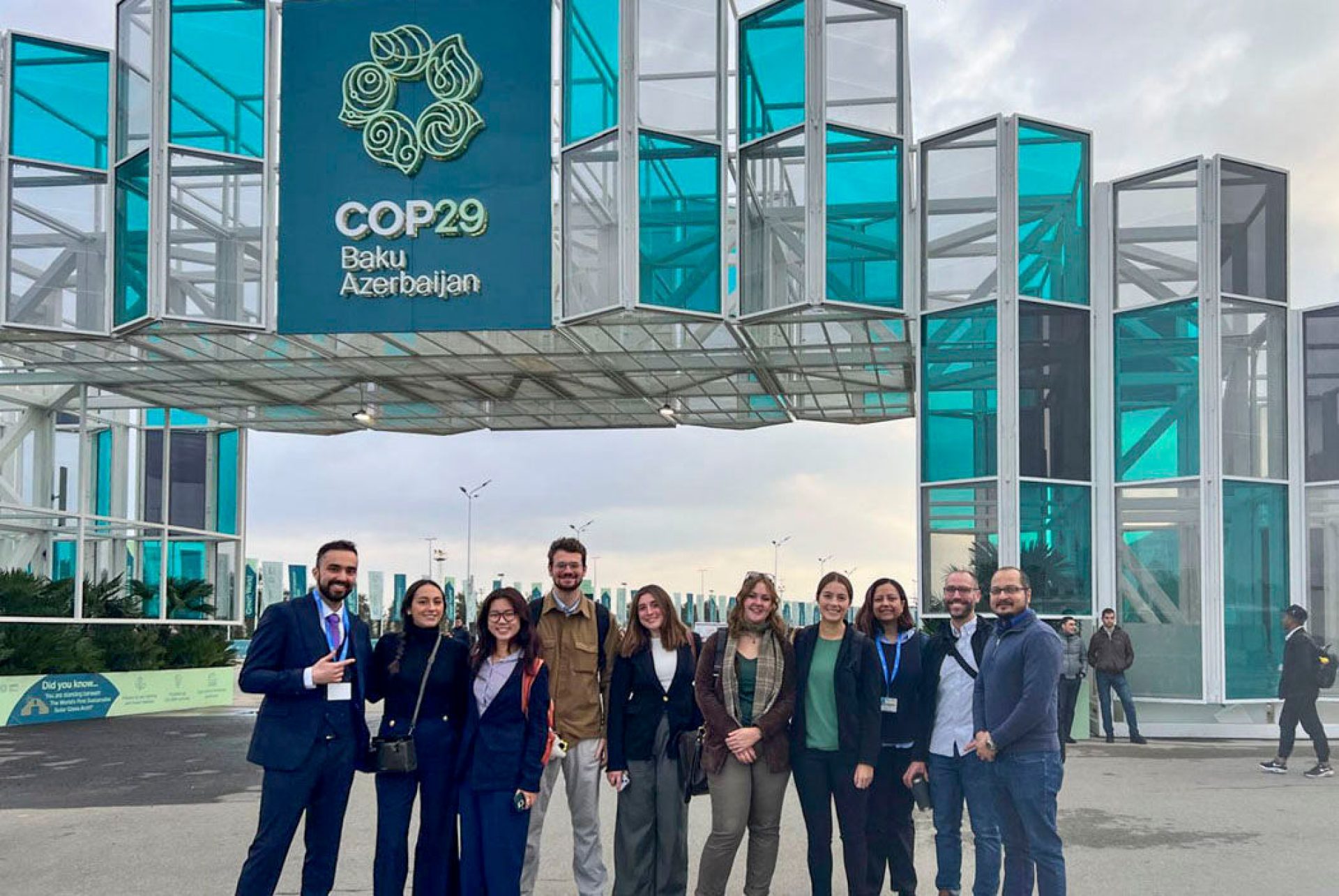 delegates in Baku in front of COP29 signage