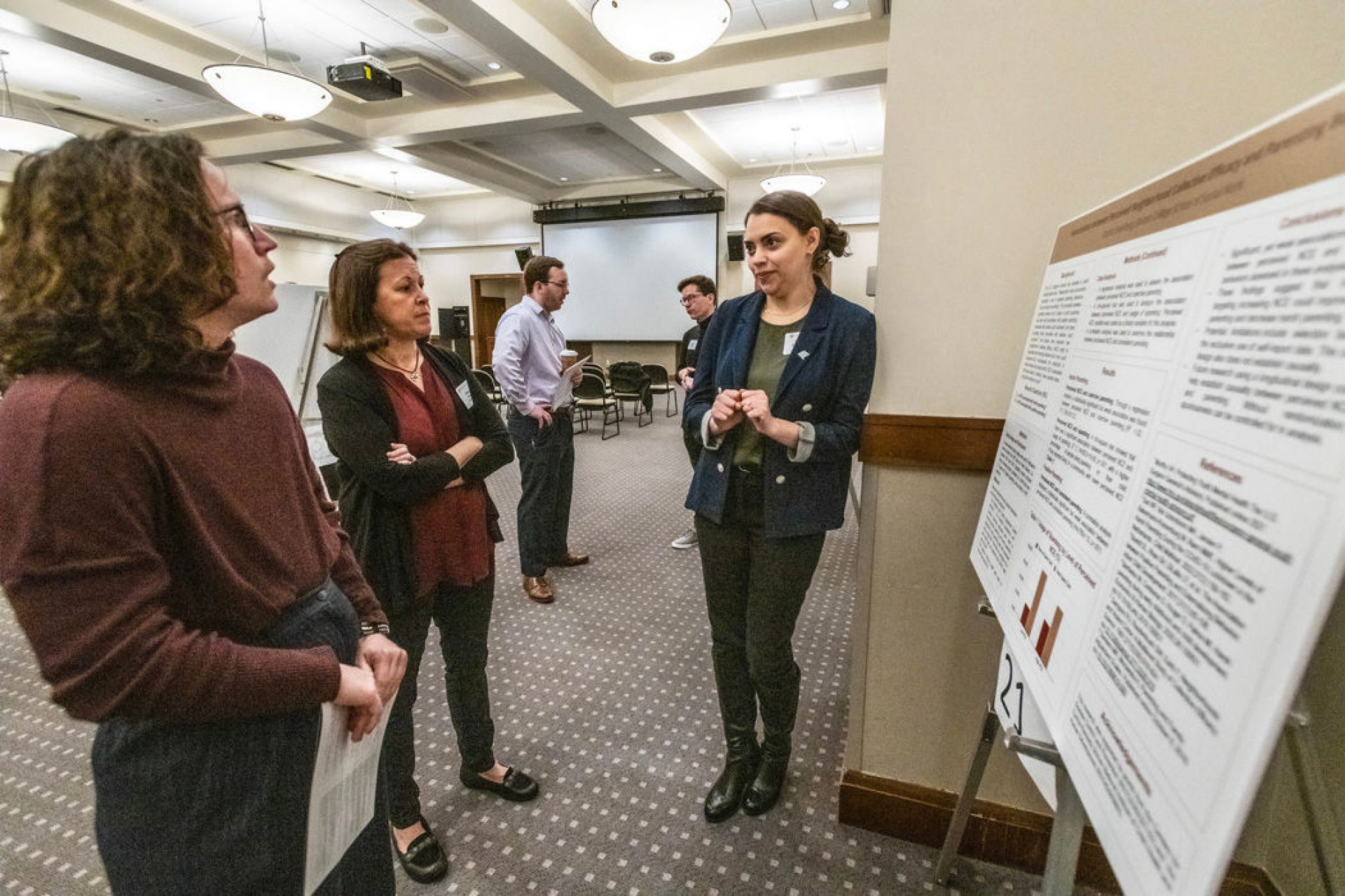 a student presents research to onlookers