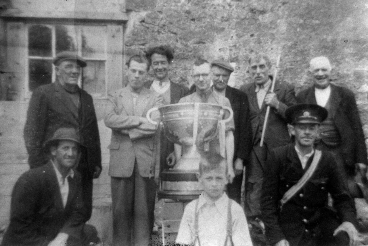 A group of people standing with a cup