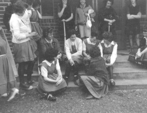 A group of young women sitting on steps