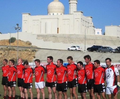 A group of soccer players wearing red uniforms