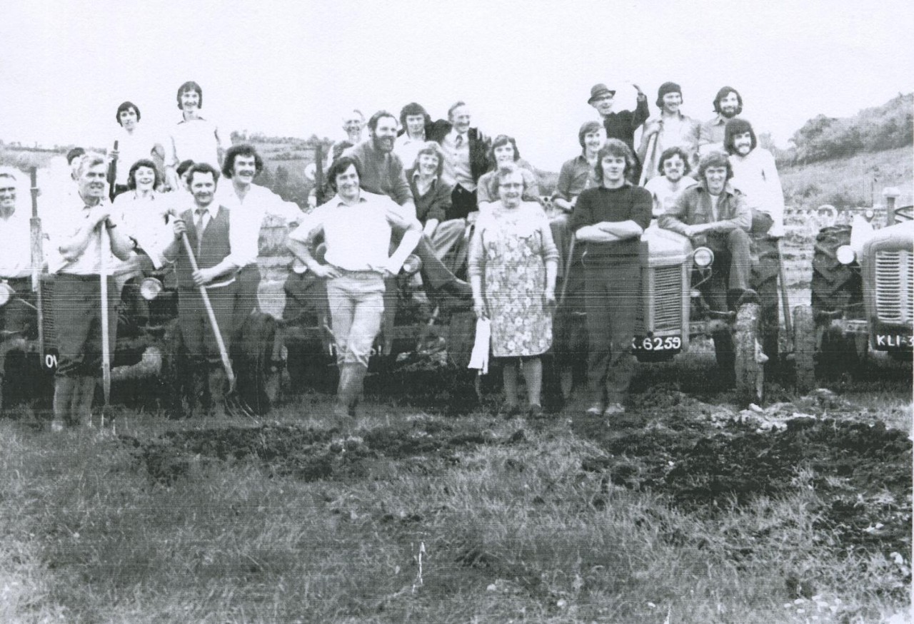 Several genHardworking members of Seán O'Heslin's GAA Club, Ballinamore, Co. Leitrim, take a break from developing their new playing field to pose for a photograph.erations of Roche Emmets GAA Club in County Louth help remove the goalposts from Treanor's field as the club prepares to move to new facilities in 1983.