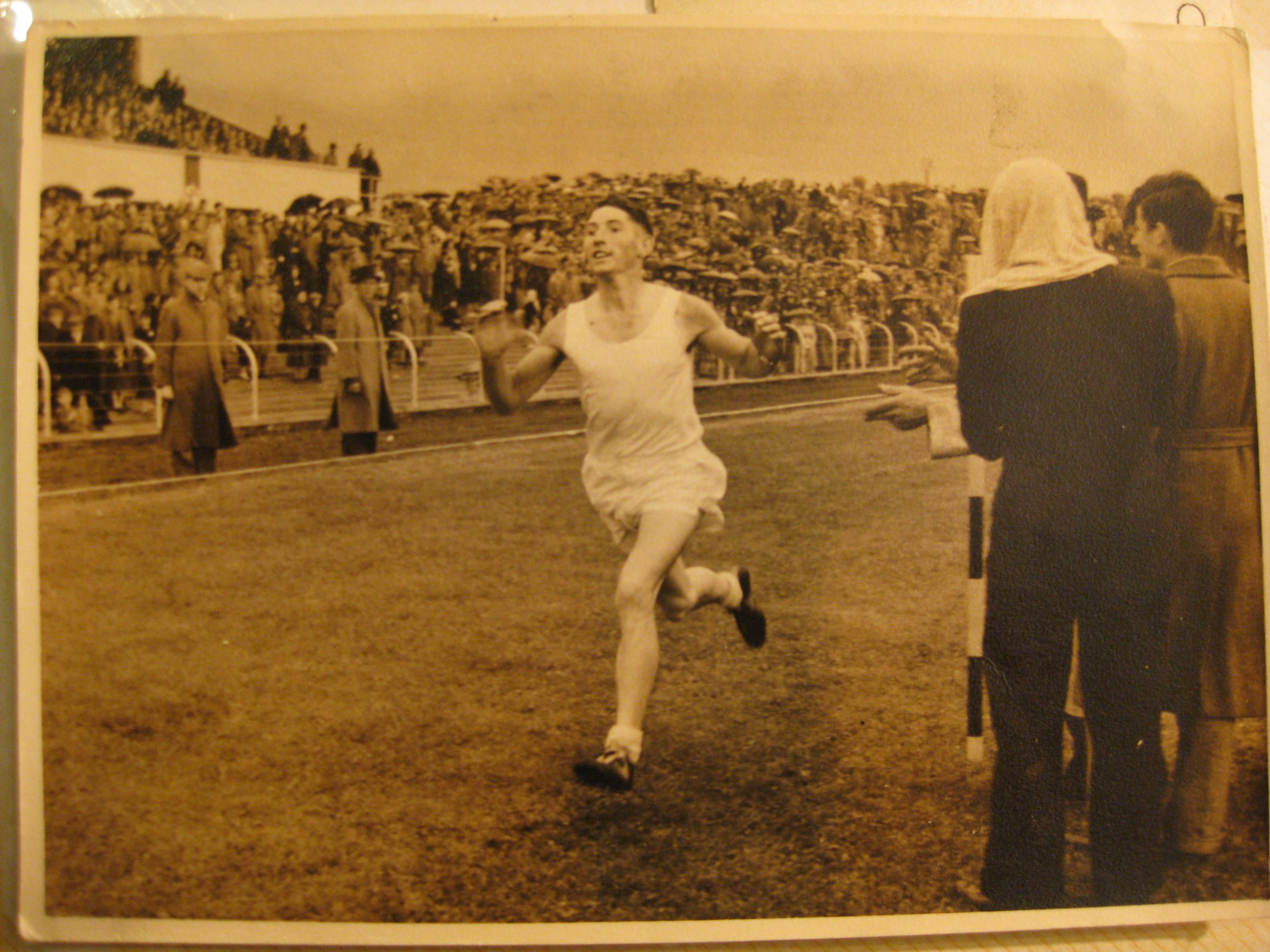 Brian O'Gara enters Casement Park on the final leg of the relay organised to celebrate the official opening of the park in June 1953. The relay involved the carrying of an urn of soil from Semple Stadium in Thurles to Croke Park and on to Casement Park.
