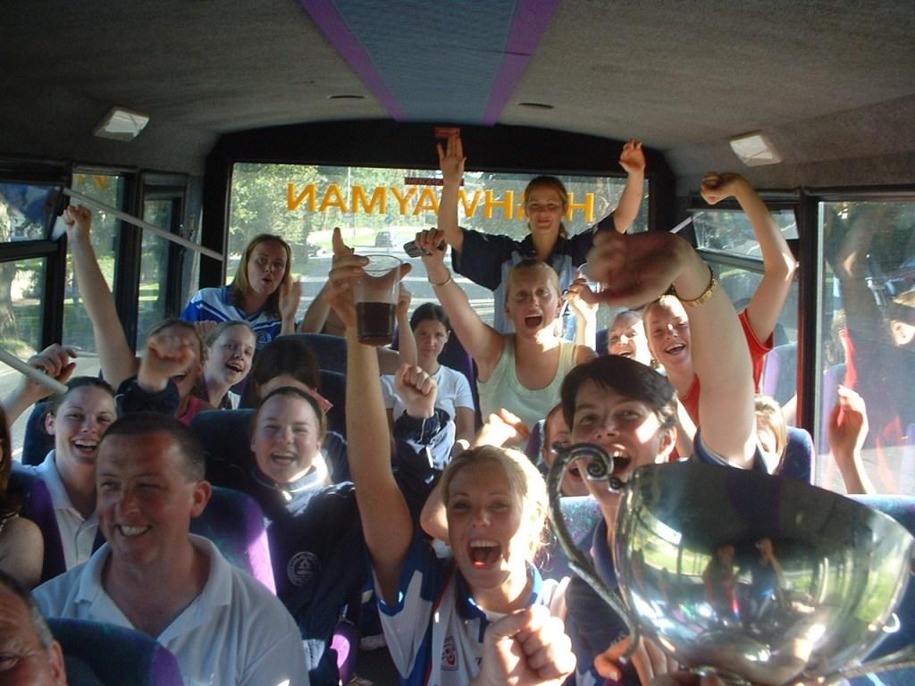 Loughinisland Ladies Football Team, Co. Down, celebrate their intermediate championship win on their team bus, 2004.