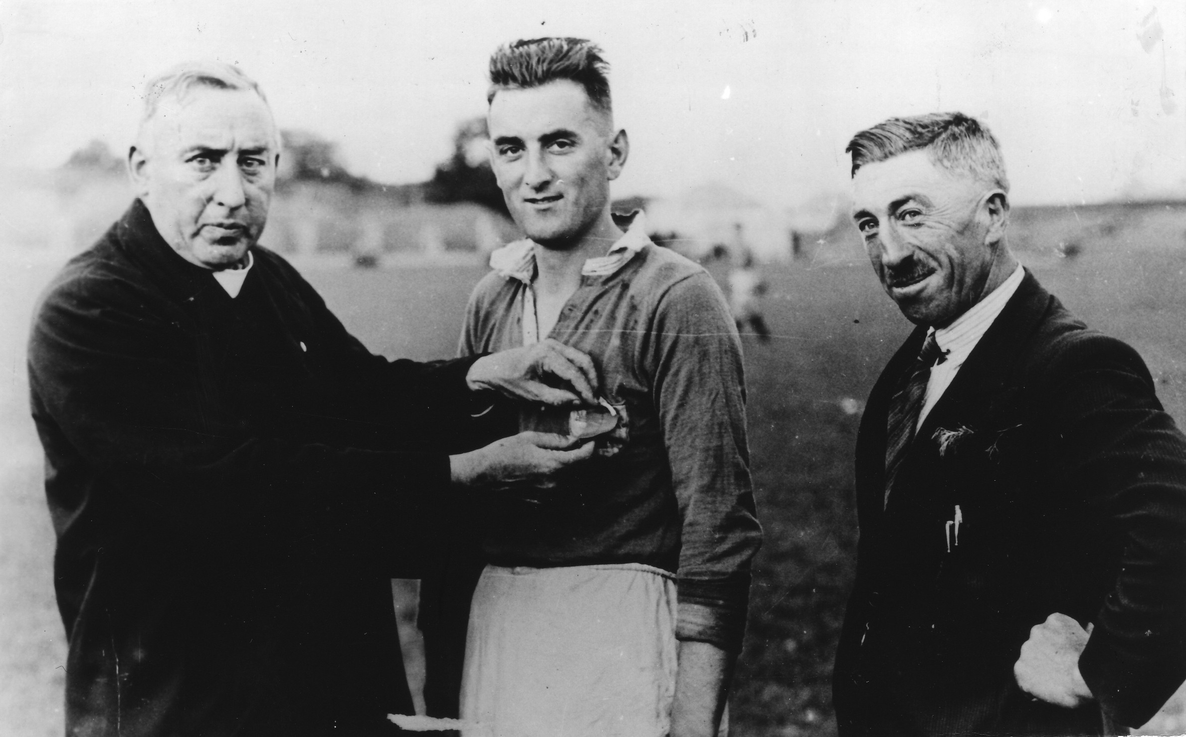 Fr JJ Meagher, Chairman of Tipperary County Board, makes a presentation to Jim Lanigan, captain of the 1937 Tipperary All-Ireland winning team. Also included is County Secretary Johnny Leahy.