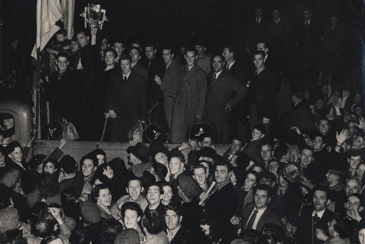 Members of the All-Ireland winning Tipperary team aboard a lorry, hold aloft the Liam McCarthy Cup as they arrive to their homecoming reception.