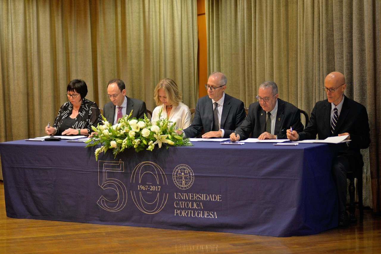 a panel of scholars signing an agreement