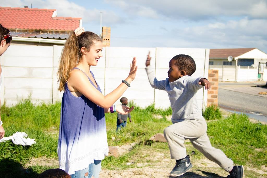 woman high-fiving child