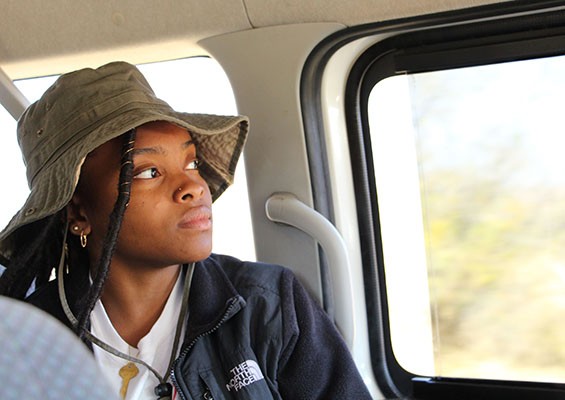 woman stares out window sitting inside car