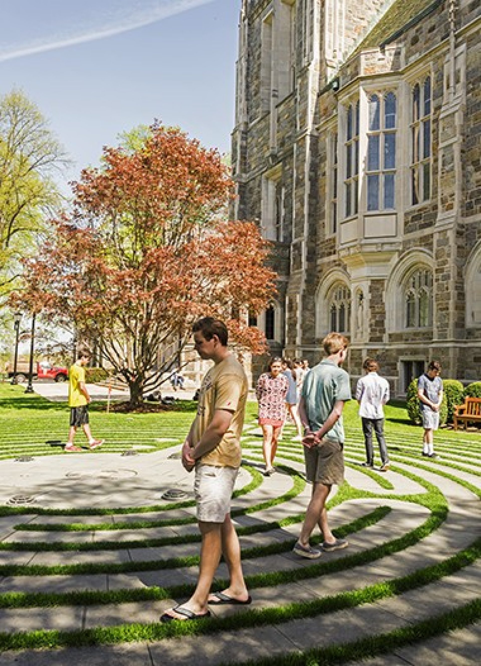 People walking through a stone labryinth