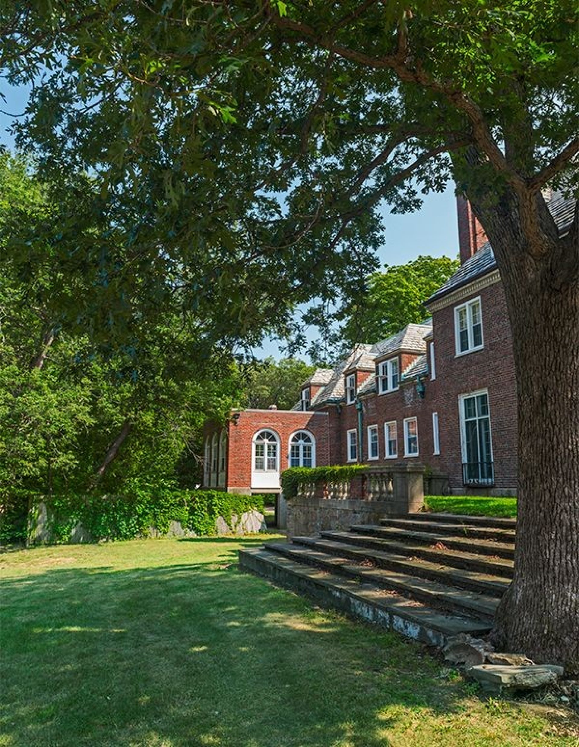 A lawn with stone steps leading to a house