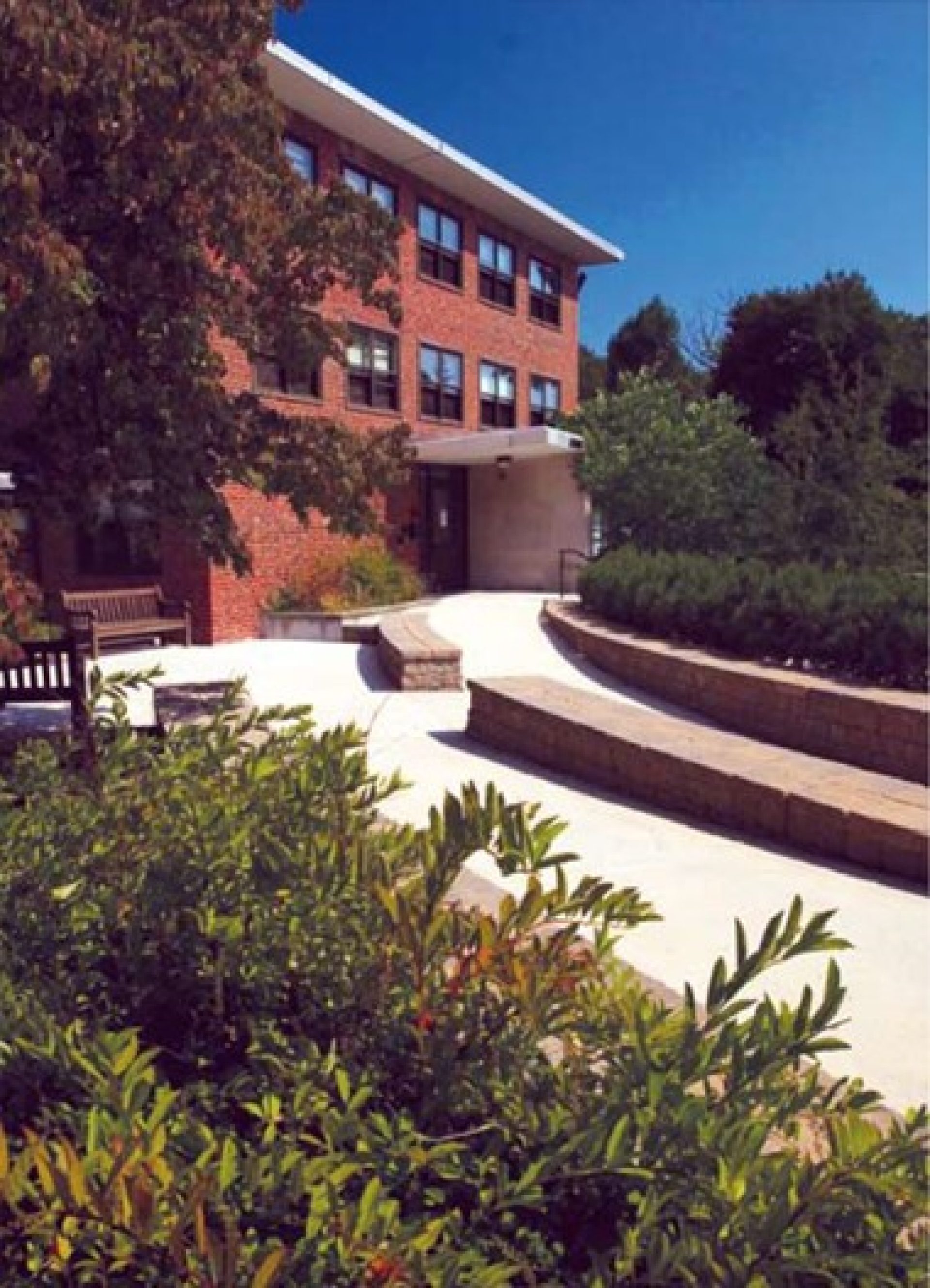 A patio behind a brick building