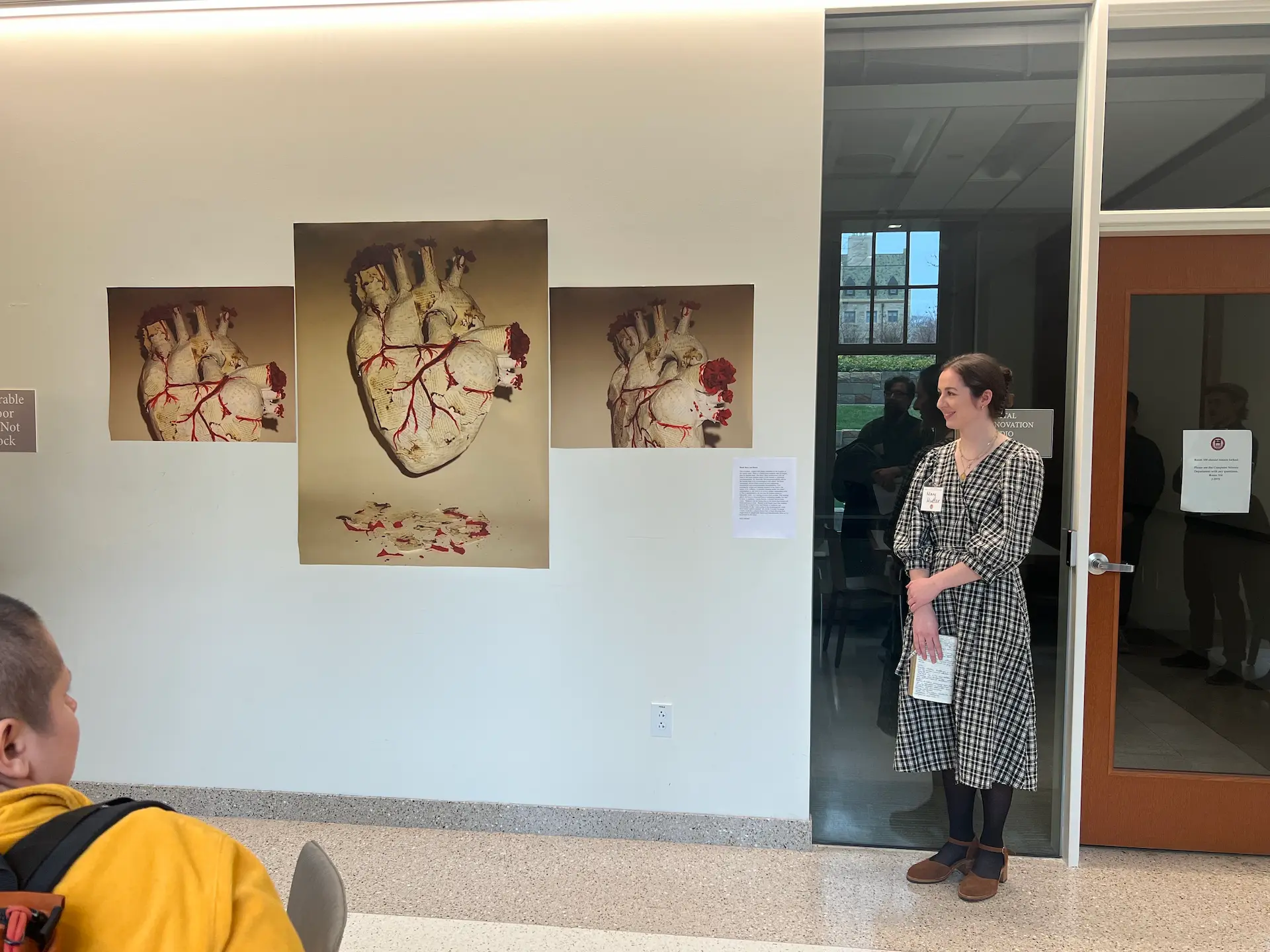 Mary Mueller and her art work displayed