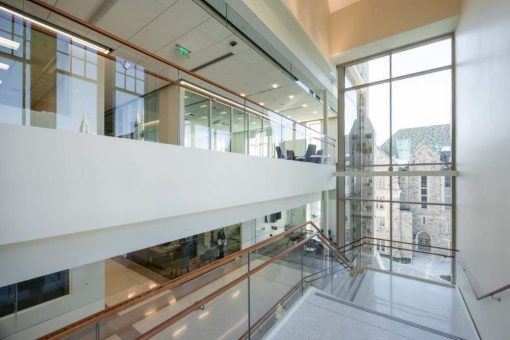 The sunlit main staircase offers views of campus.