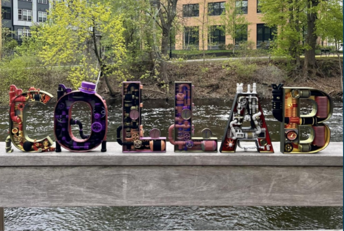 COLLAB in metal lettering over the Charles RIver