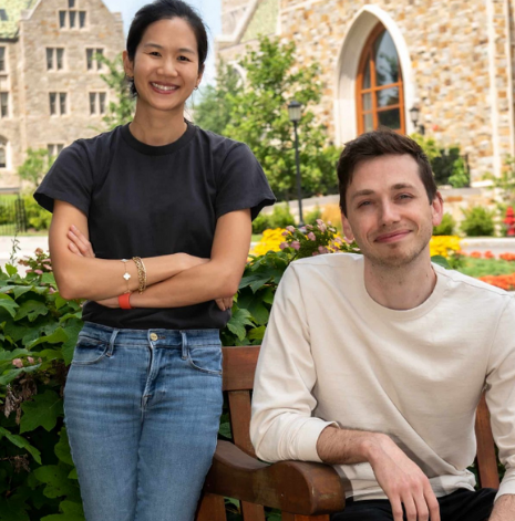 Liane Young and Isaac Handley posing on a bench