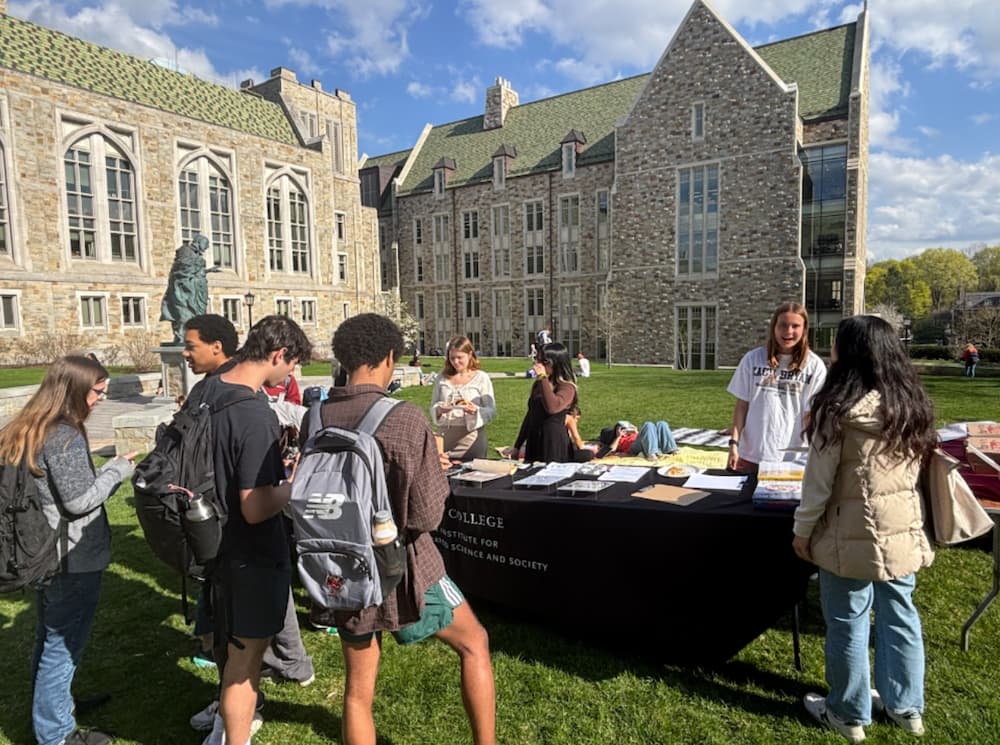 Students around Green Week activity table sponsored by the Schiller Institute
