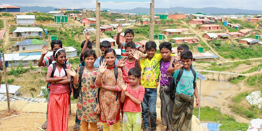 A group of children waving