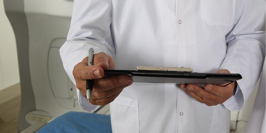 A doctor holding a clipboard