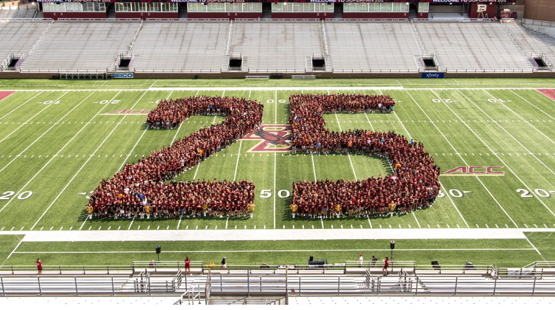 students form the number 25 on the field in Alumni Stadium