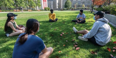 Masked students on lawn