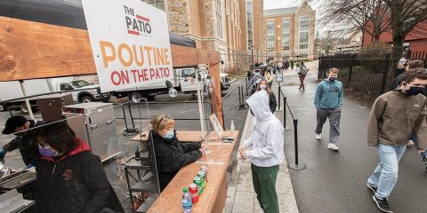 Students waiting in line at an outdoor food kiosk