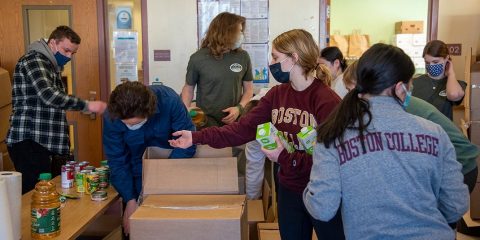 A group of students packing boxes