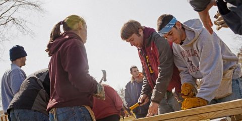 Students at work building a house