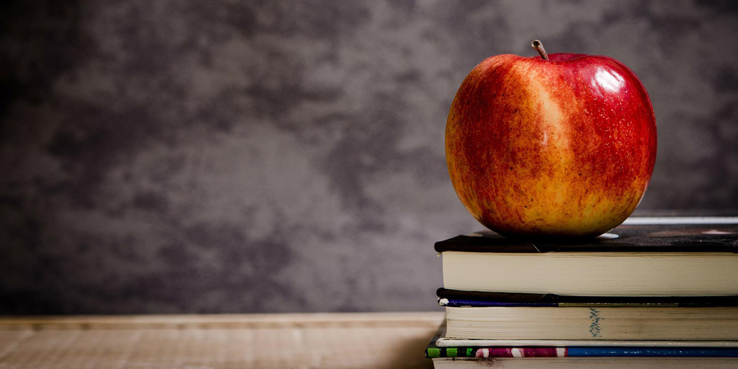 an apple on a stack of books