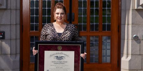 Dina Coughlan holding her diploma