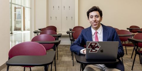 Luke Stanise sitting at a desk with a laptop