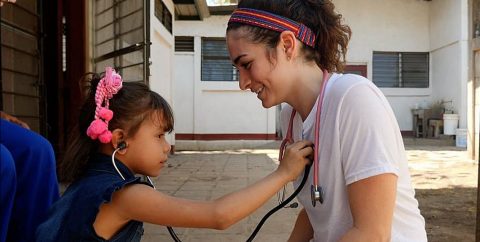 Connell School student tends to a child in Nicaragua